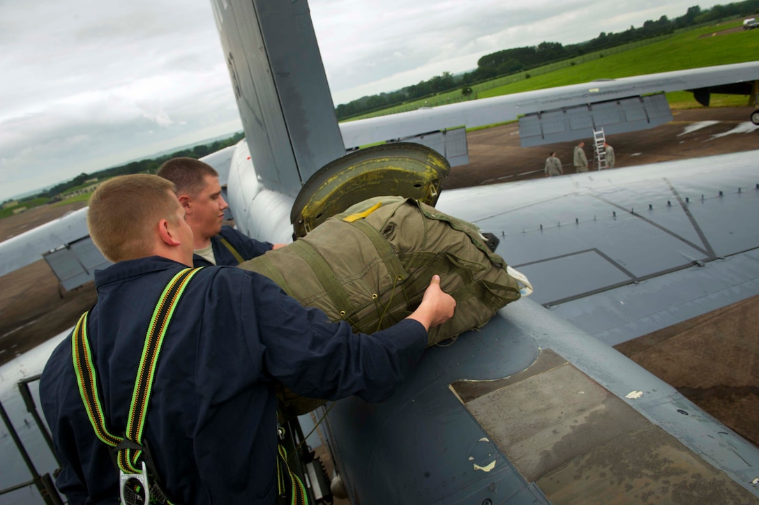 (From left) U.S. Air Force Staff Sgts. Matthew Hardwig and Justin Yochum, 5th Expeditionary Maintenance Squadron aerospace repair and reclamation craftsman and journeyman, place a drag chute into a B-52H Stratofortress at RAF Fairford, United Kingdom, June 13, 2016, following a Saber Strike 16 mission. The drag chute is a 43.5-foot diameter ribbon-type chute which consists of a pilot chute, long bridle, short bridle, main chute, riser terminal and riser boot. (U.S. Air Force photo/Senior Airman Sahara L. Fales)