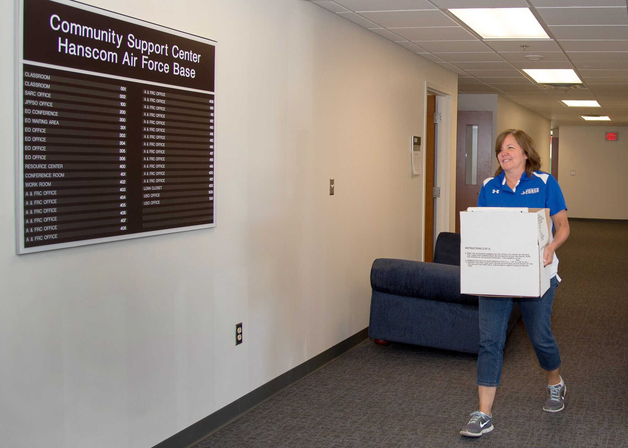 Laurel Wironen, Hanscom’s school liaison specialist, carries a box into the new Hanscom Community Center located in Building 1240 on base June 15. Members of the Airman and Family Readiness Center and other base organizations will be moving into the building during the next few weeks. (U.S. Air Force photo by Mark Herlihy)