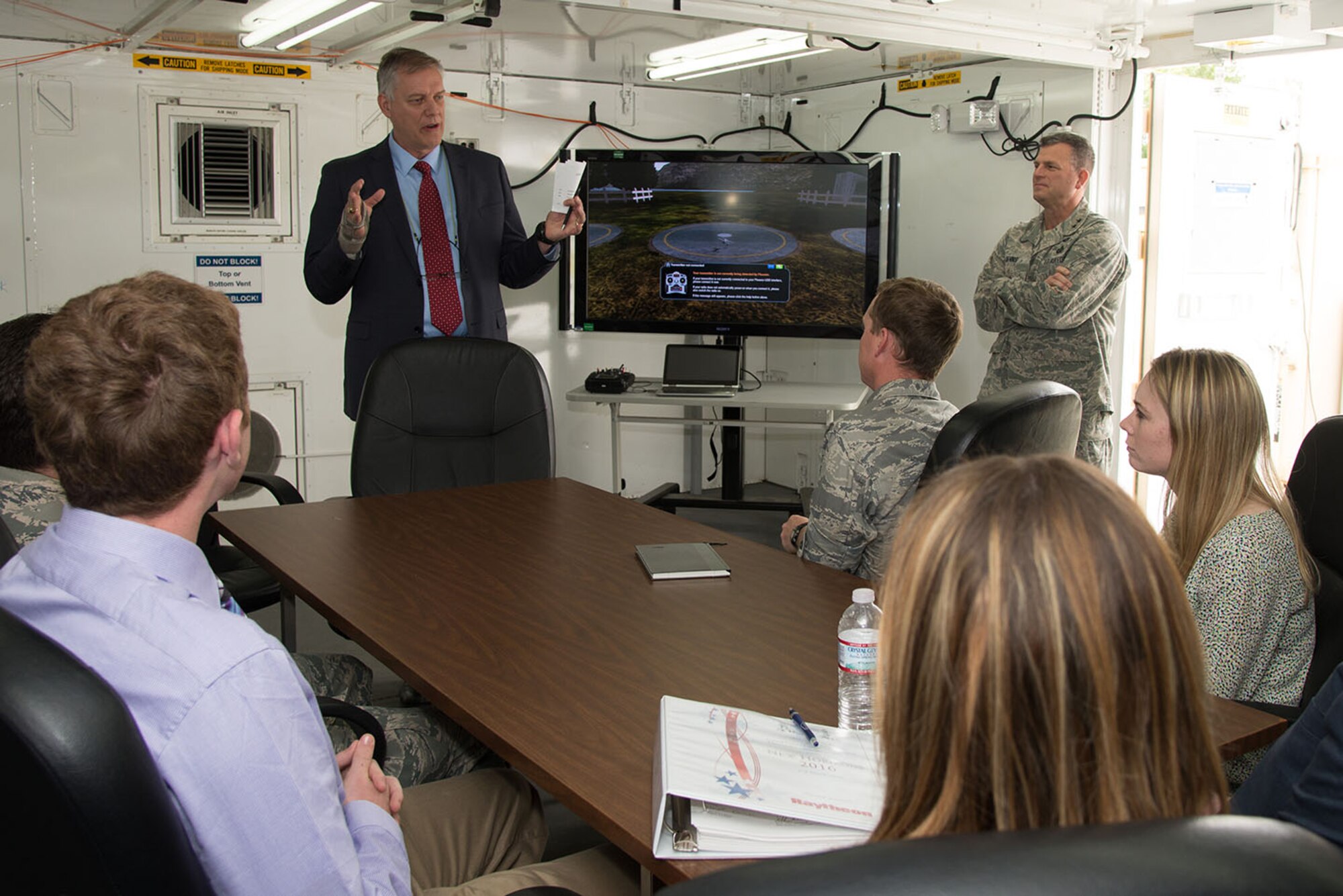 Dennis Miller, Hanscom’s associate director for Engineering and Technical Management, speaks to members of the Hanscom Air Force Base team who will be participating in the 2016 Air Force Research Laboratory Commanders Challenge, while Maj. Gen. Dwyer L. Dennis, C3I and Networks program executive officer, looks on, during a kick-off meeting at the base June 9. The Hanscom team will compete against other teams from across Air Force Materiel Command to design, develop and demonstrate an innovative solution to an urgent warfighter need. (U.S. Air Force photo by Mark Herlihy)