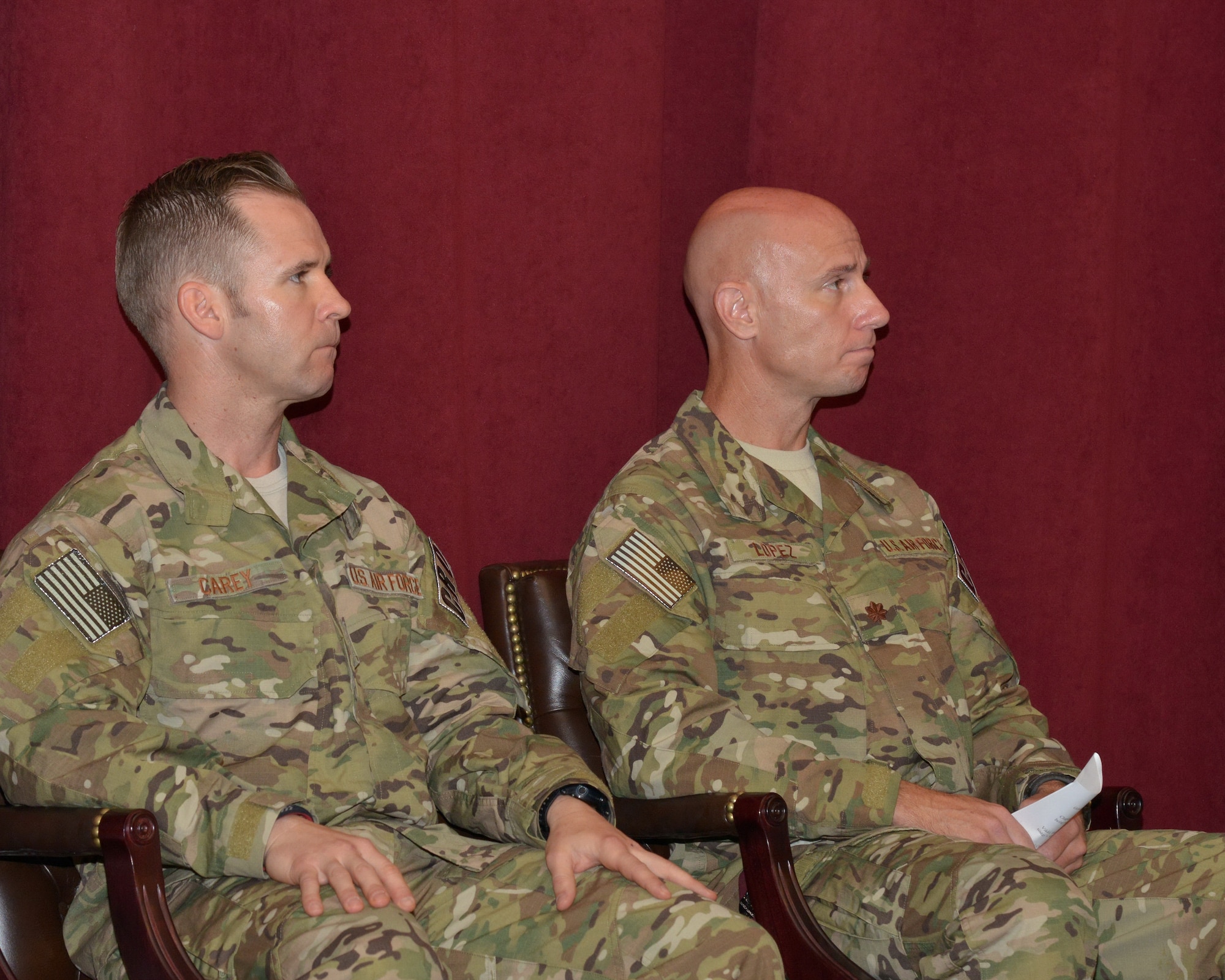 Capt. Brian Carey, left, former commander of the 342nd Training Squadron Det. 1, and Maj. Joseph Lopez, who assumed command of the new 351st Battlefield Airmen Training Squadron, listen during the BATS activation ceremony June 14 at the Pararescue Schoolhouse Amphitheater. (Photo by Jamie Burnett)