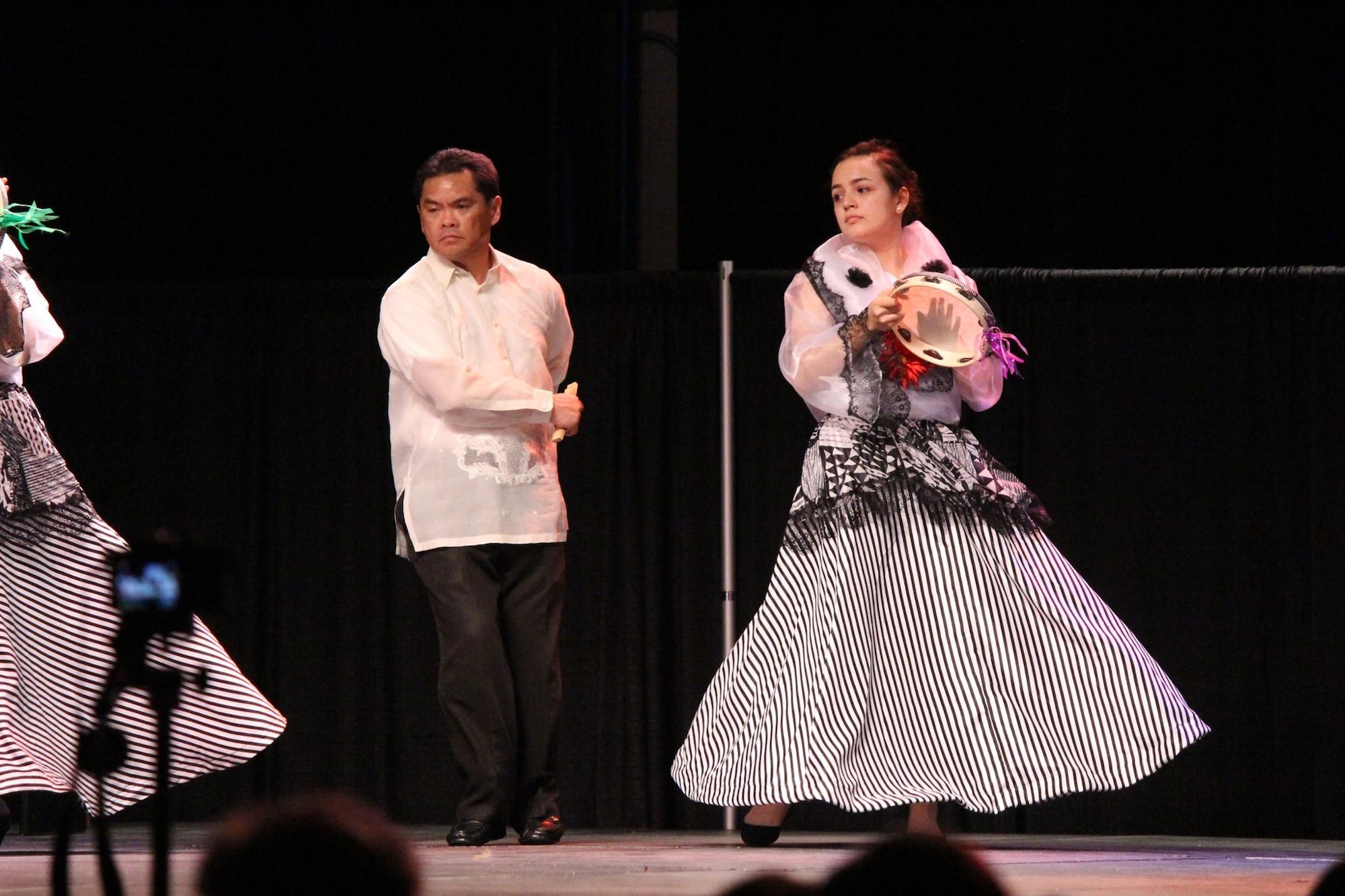 Armin M. Sayson, lead engineer for Headquarters Air Force Material Command, and a member of the traditional Filipino dance group called Pamana perform a traditional Philippine dance at the Wright-Patterson Club for a past International Fair. (Contributed photo/Armin M. Sayson)