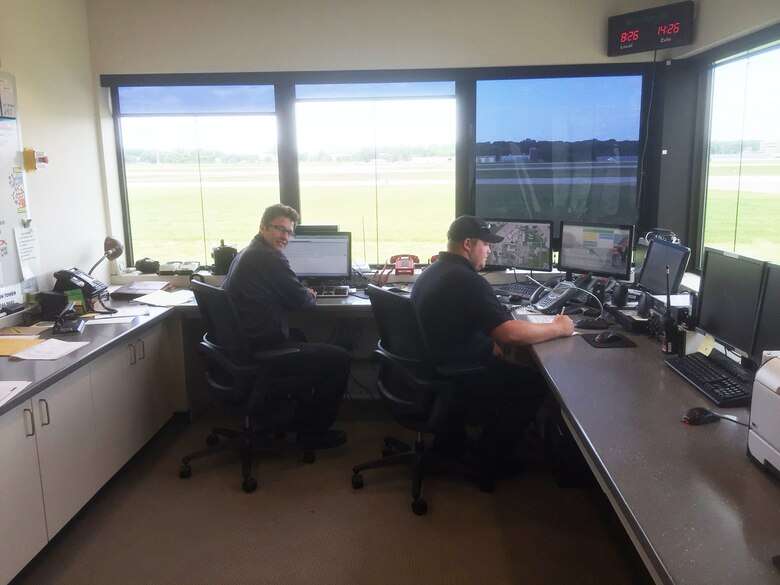 Firefighters from the 115th Fighter Wing Truax Fire and Emergency Services work in the alarm room of the department in Madison, Wis., June 6, 2016. The two firefighters helped save a woman's life by making vital calls during an emergency situation May 24, 2016. (Photo courtesy of Master Sgt. Gary Peck)