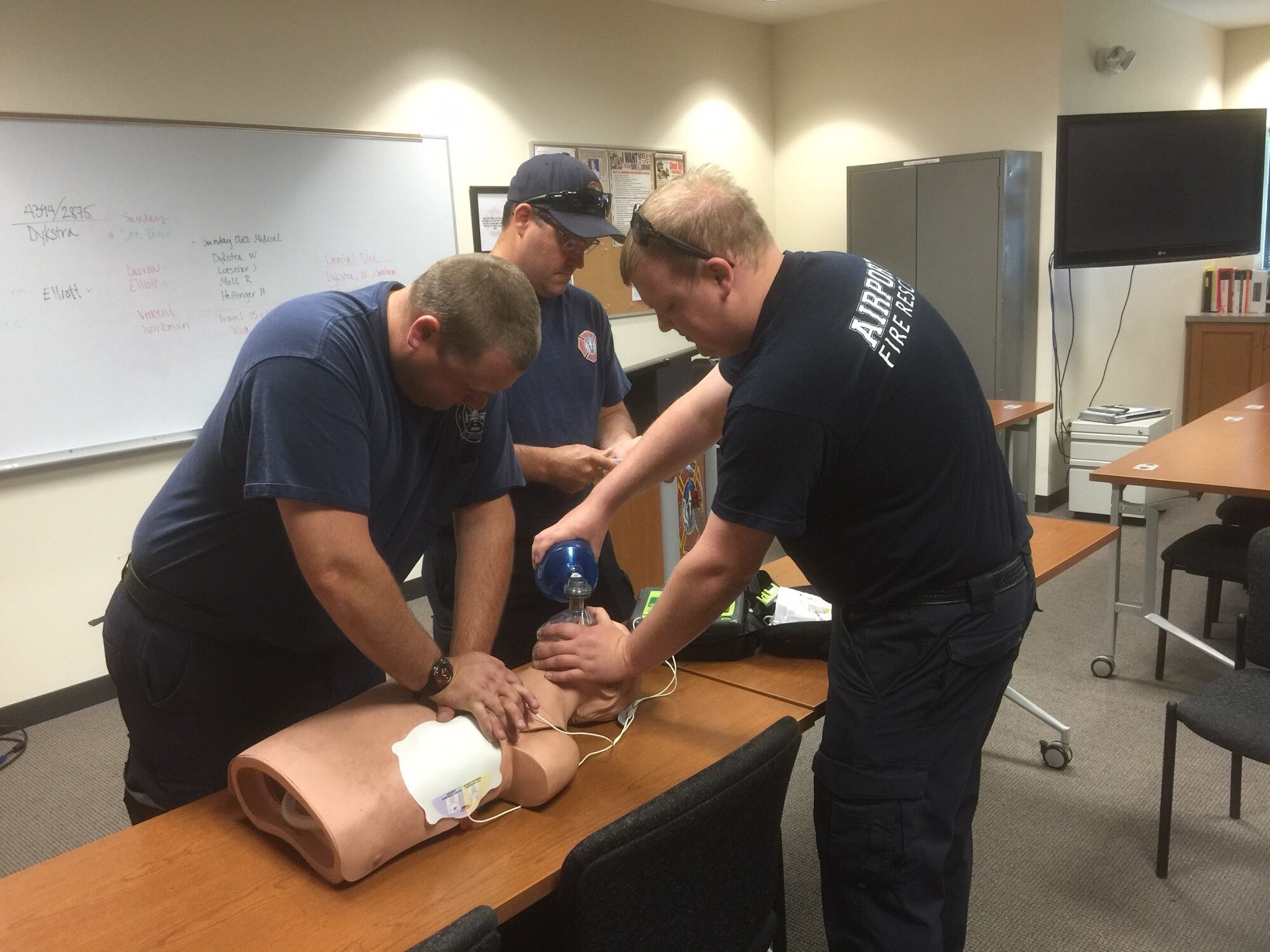 Firefighters from the 115th Fighter Wing Truax Fire and Emergency Services re-enact their cardiopulmonary resuscitation training in Madison, Wis., June 6, 2016. The three firefighters completed CPR training, a lifesaving technique used when someone's heartbeat has stopped or that person is not breathing, the morning before they recieved a call to save a woman's life during an emergency situation at Dane County Regional Airport on May 24, 2016. (Photo courtesy of Master Sgt. Gary Peck)