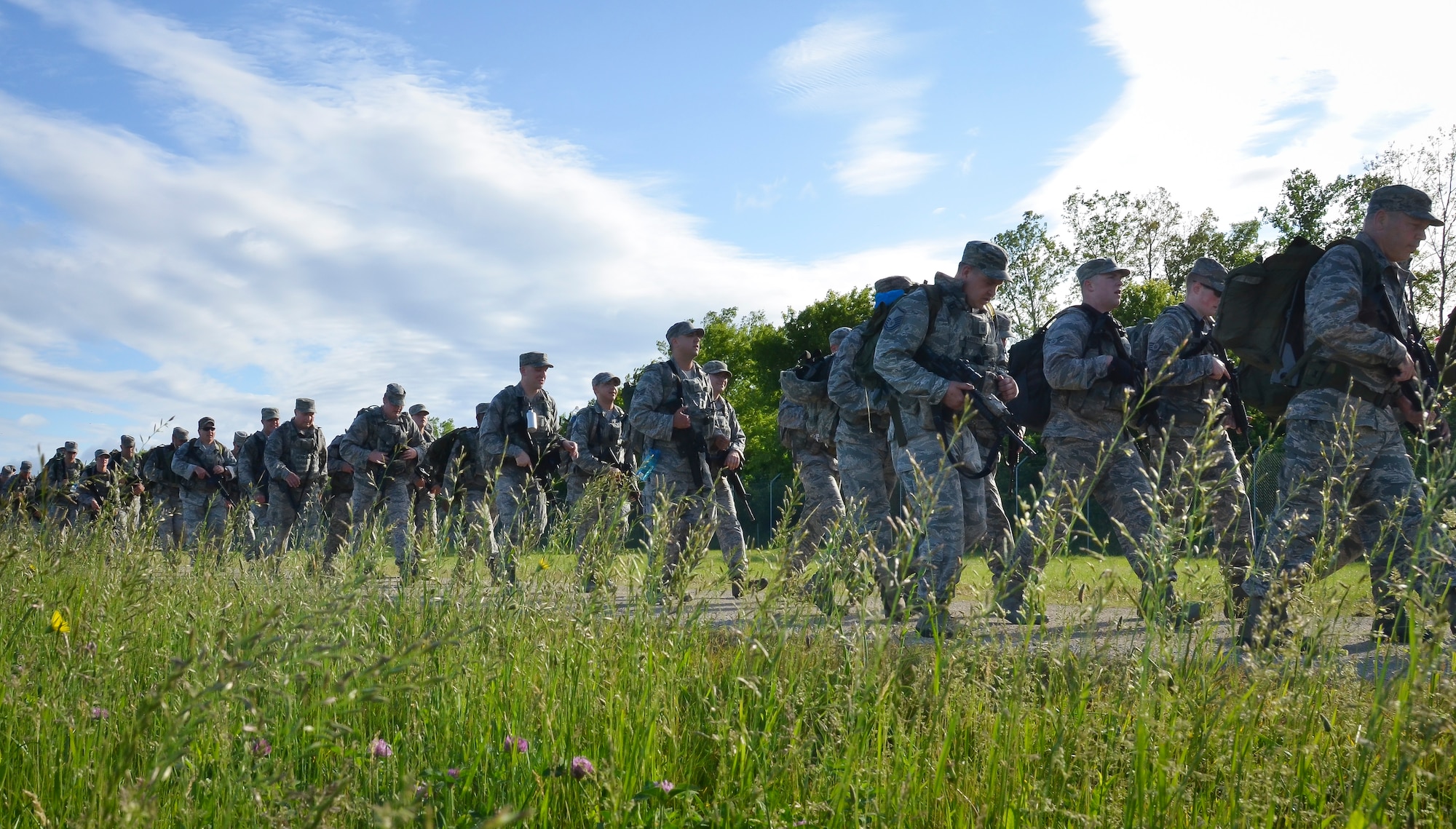 The Security Forces Squadron Airmen with the 128th Air Refueling Wing, Wisconsin Air National Guard, participate in a ruck march June 5, 2016, at General Mitchel International Airport. The march was in honor of Staff Sgt. Louis M. Bonacasa and Technical Sgt. Joseph G. Lemm who, along with four other Airmen, lost their lives in Afghanistan to a suicide bomber attack. (U.S. Air National Guard photo by Senior Airmen Morgan R. Lipinski/Released)
