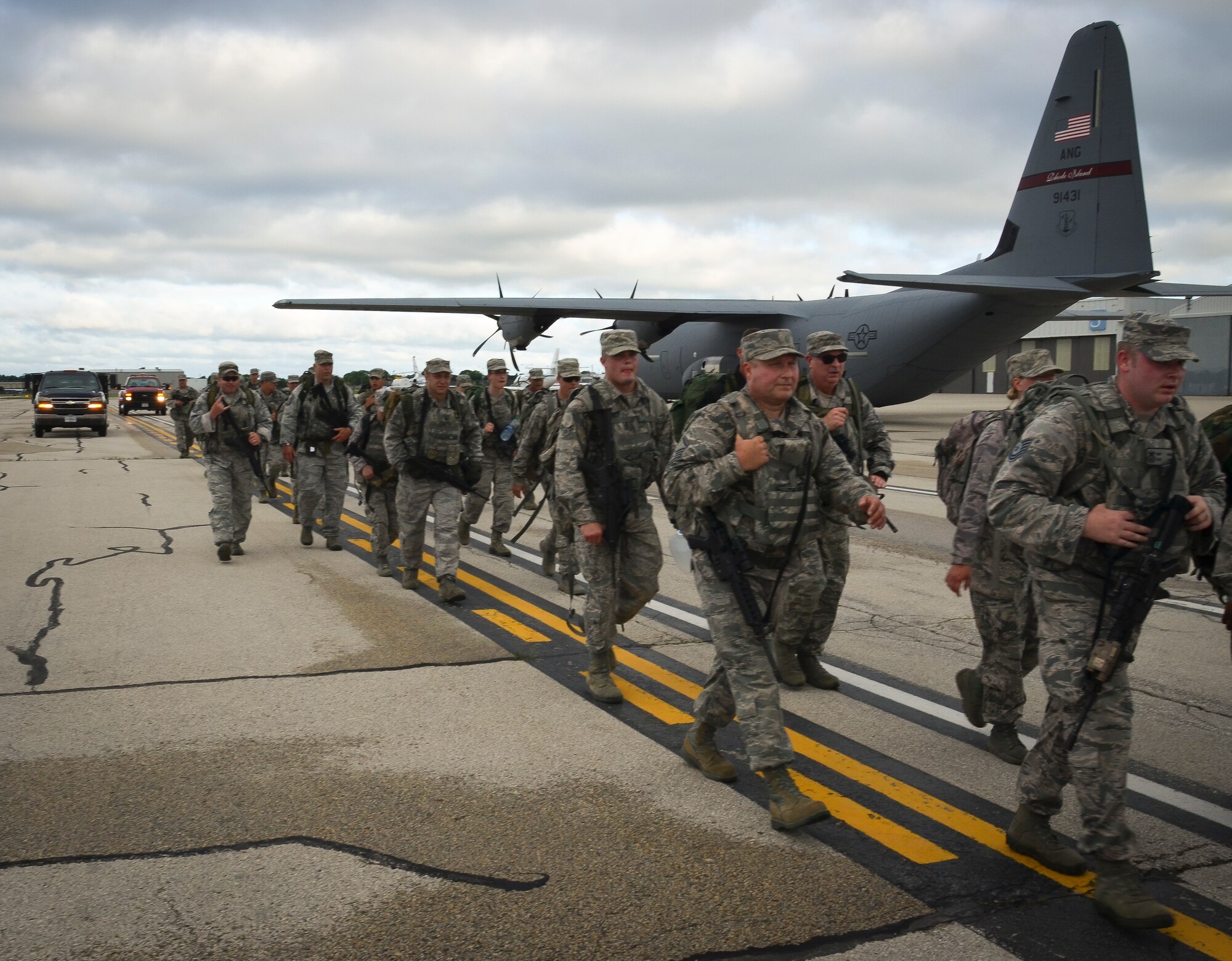 The Security Forces Squadron Airmen with the 128th Air Refueling Wing, Wisconsin Air National Guard, participate in a ruck march June 5, 2016, at General Mitchel International Airport. The march was in honor of Staff Sgt. Louis M. Bonacasa and Technical Sgt. Joseph G. Lemm who, along with four other Airmen, lost their lives in Afghanistan to a suicide bomber attack. (U.S. Air National Guard photo by Senior Airmen Morgan R. Lipinski/Released)