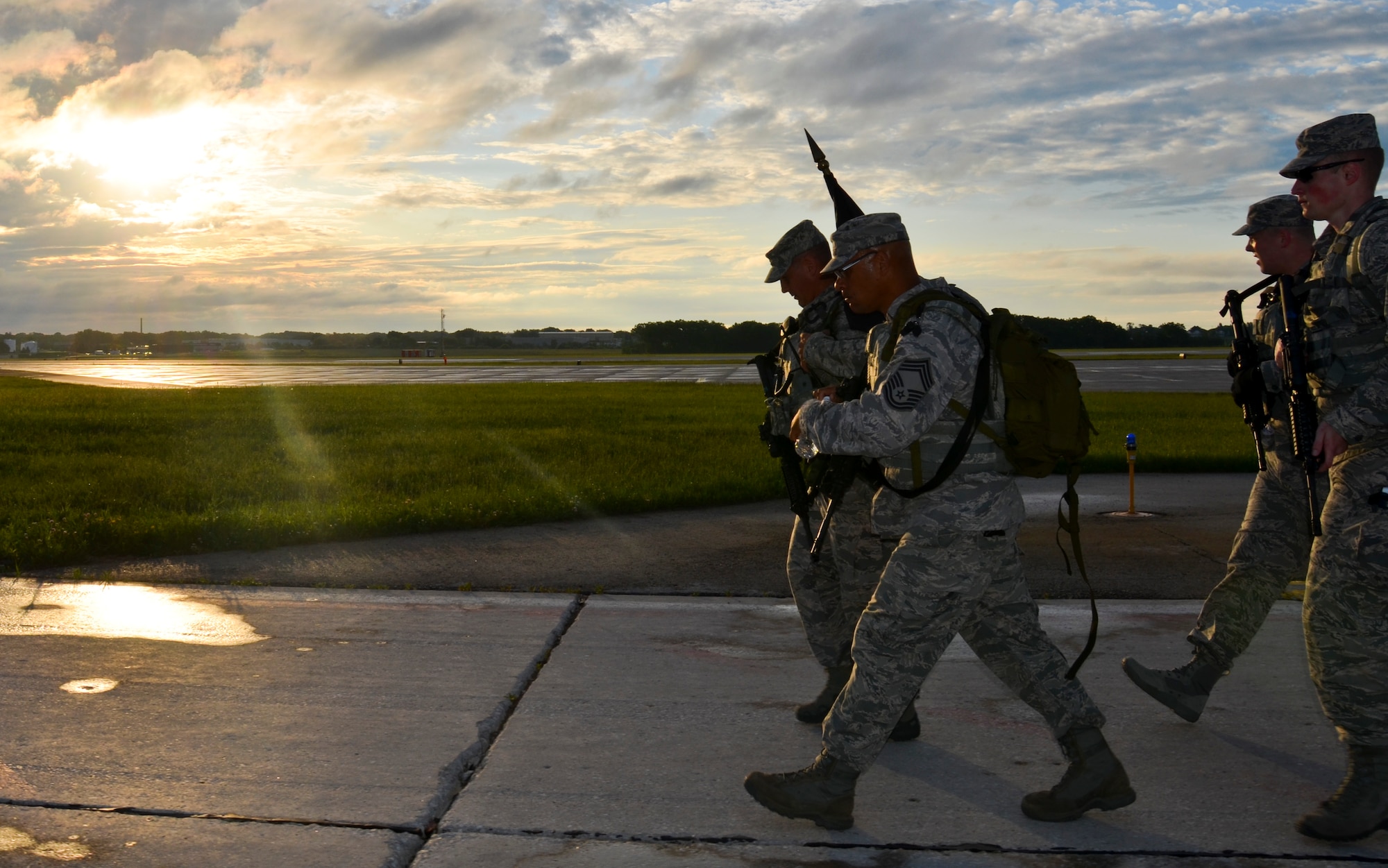 The Security Forces Squadron Airmen with the 128th Air Refueling Wing, Wisconsin Air National Guard, participate in a ruck march June 5, 2016, at General Mitchel International Airport. The march was in honor of Staff Sgt. Louis M. Bonacasa and Technical Sgt. Joseph G. Lemm who, along with four other Airmen, lost their lives in Afghanistan to a suicide bomber attack. (U.S. Air National Guard photo by Senior Airmen Morgan R. Lipinski/Released)