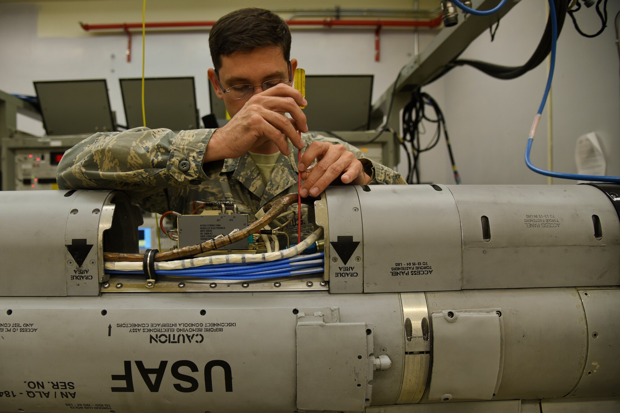 U.S. Air Force Tech. Sgt. William Rus, a 187th EW technician and production supervisor, Montgomery Regional Air National Guard Base, Ala., demonstrates how he works on an AN/ALQ-184 ECM pod June 2, 2016, at the Montgomery Regional ANGB, Ala. The purpose of the pods are to jam radar or other detection systems. The pods keep the wing’s F-16 Fighting Falcon and pilots safe when flying into enemy territory. (U.S. Air National Guard photo by Airman 1st Class Hayden Johnson/Released)