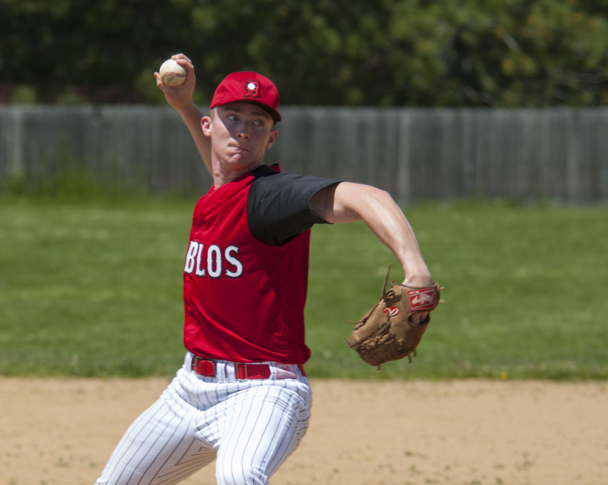 Senior Airman Devin Mooney, 321st Missile Squadron commander's support staff and Personnel Reliability Program monitor, pitches the ball during a Fort Collins league baseball game May 29, 2016, on a baseball field in Colorado. Mooney claims his pitching style is a mix between sling-shotting the ball and gunning it into the catcher's mitt with raw power. (U.S. Air Force photo by Senior Airman Jason Wiese)