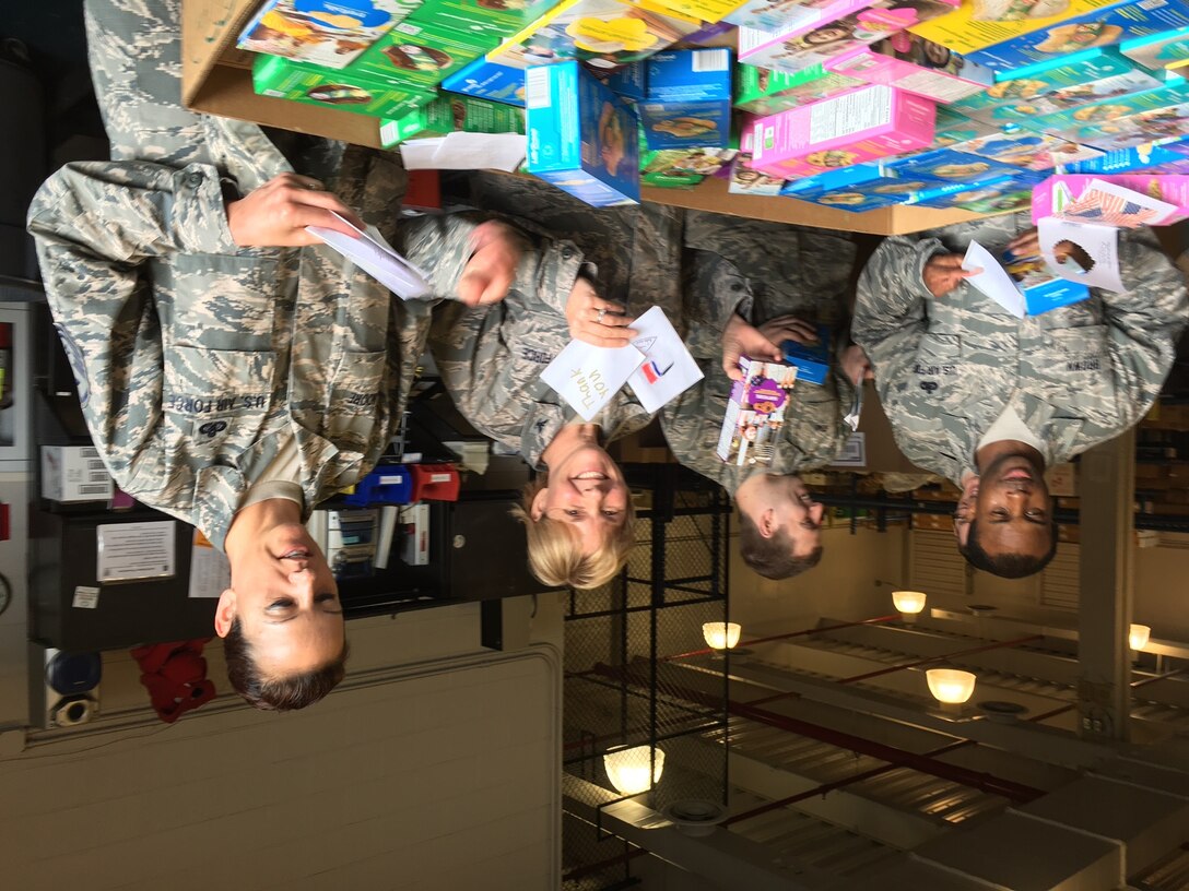 79th Medical Wing Commander, Colonel Sharon Bannister, (center right) and her Airmen discovered hand written notes from the Girl Scouts of Hudson Valley Region, New York who sent over 6000 cookies to the service members at Joint Base Andrews. Thank you Girl Scouts!  (US Air Force Photo by Melanie Moore/Released)