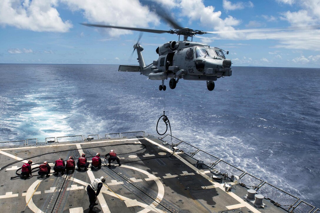 An MH-60R Seahawk helicopter participates in a vertical replenishment practice exercise on the flight deck of the USS Spruace in the Pacific Ocean, June 14, 2016. The Spruance is supporting maritime security and stability in the Indo-Asia-Pacific region. Navy photo by Petty Officer 2nd Class Will Gaskill