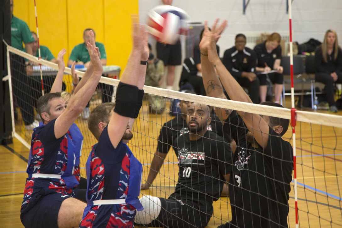 Team Army athletes, right, attempt to block a spike while participating in a sitting volleyball match against the British team during the 2016 Department of Defense Warrior Games at the U.S. Military Academy in West Point, N.Y., June 15, 2016. Army photo by Spc. Sarah Pond