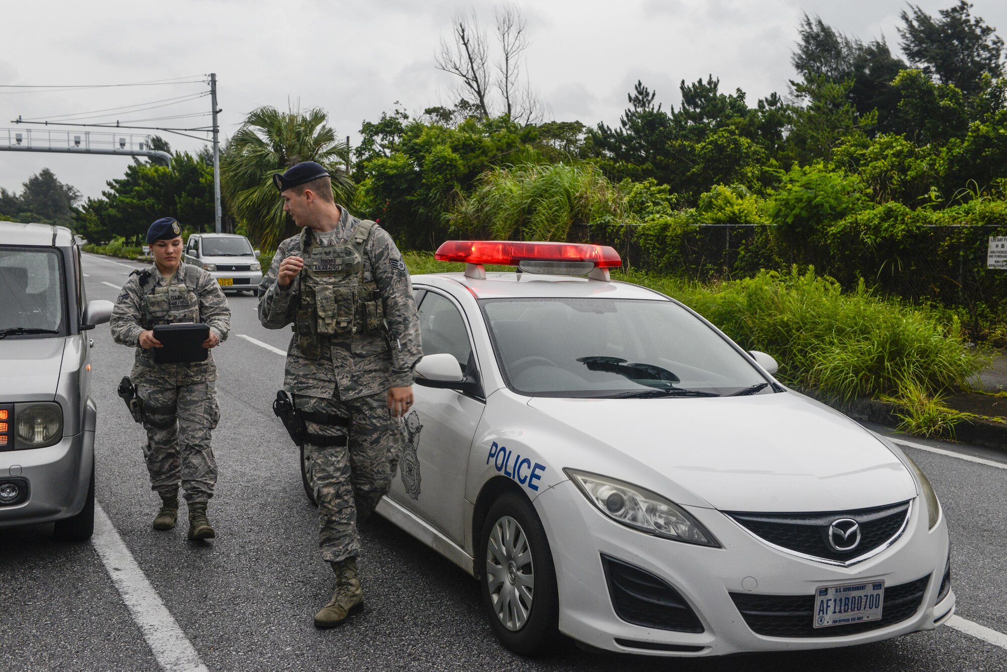 Staff Sgt. Troy Turnbo and Airman 1st Class Rachel Dolan, 18th Security Forces Squadron patrolmen, respond to a minor vehicle accident near Kadena Air Base, Japan, June 13, 2016. The squadron has a 58-square-mile legal jurisdiction which includes seven schools and 14 housing areas. (U.S. Air Force photo by Senior Airman Stephen G. Eigel)