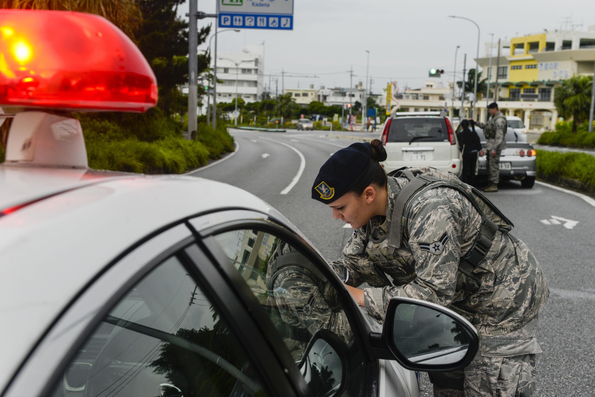 Airman 1st Class Rachel Dolan, 18th Security Forces Squadron patrolman, writes an accident report for a minor vehicle accident near Kadena Air Base, Japan, June 13, 2016.  Security forces members respond to all vehicle accidents in and around Kadena involving any Status of Forces Agreement members. (U.S. Air Force photo by Senior Airman Stephen G. Eigel)