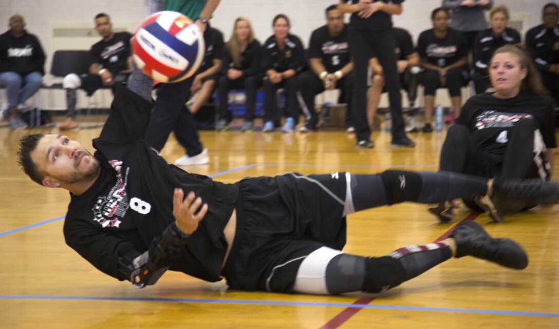 Army veteran Robbie Gaupp dives to keep the ball in play during a sitting volleyball match against the British team during the 2016 Department of Defense Warrior Games at the U.S. Military Academy in West Point, N.Y., June 15, 2016. Army photo by Spc. Sarah Pond