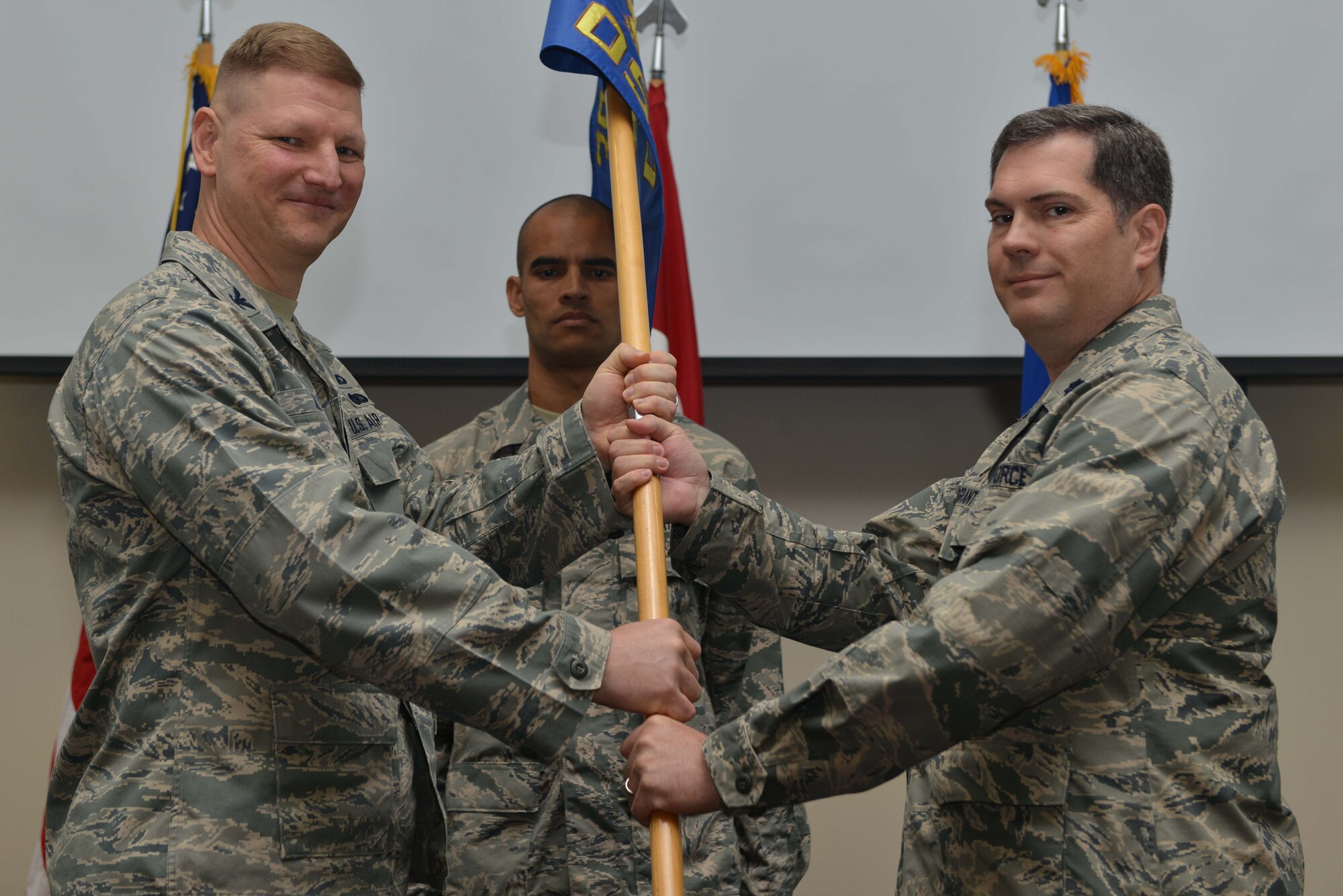U.S. Air Force Lt. Col. Robert Grant, 39th Operations Support Squadron incoming commander, receives command from U.S. Air Force Col. James Zirkel, 39th Weapons System Security Group commander, during a change of command ceremony June 16, 2016, at Incirlik Air Base, Turkey. Prior to taking command, Grant served as the chief of the commander’s action group, 3rd Air Force and 17th Expeditionary Air Force, Ramstein Air Base, Germany. (U.S. Air Force photo by Senior Airman John Nieves Camacho/Released)