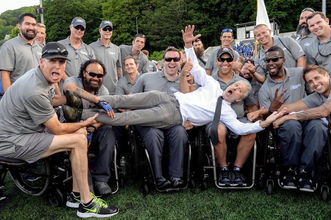 Comedian Jon Stewart poses for a picture with the Special Operations Command team before the 2016 Warrior Games opening ceremony at the U.S. Military Academy, West Point, N.Y., June 15, 2016. Approximately 250 wounded, ill and injured service members and veterans will compete for gold in eight sporting events from June 15  through June 21. DoD photo by EJ Hersom