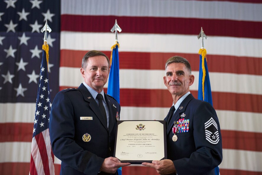 U.S. Air Force Chief Master Sgt. John Brinkley, 23d Maintenance Group superintendent, right, receives a certificate of retirement from Maj. Gen. Stephen Clark, director for force structure, requirements, resources and strategic assessments (J8), Headquarters U.S. Special Operations Command, during his retirement ceremony, June 10, 2016, at Moody Air Force Base, Ga. As the superintendent, Brinkley was responsible for ensuring the safe and reliable maintenance of Moody’s A-10C Thunderbolt IIs, HH-60G Pave Hawks and HC-130J Combat King IIs. (U.S. Air Force photo by Airman 1st Class Greg Nash/Released) 