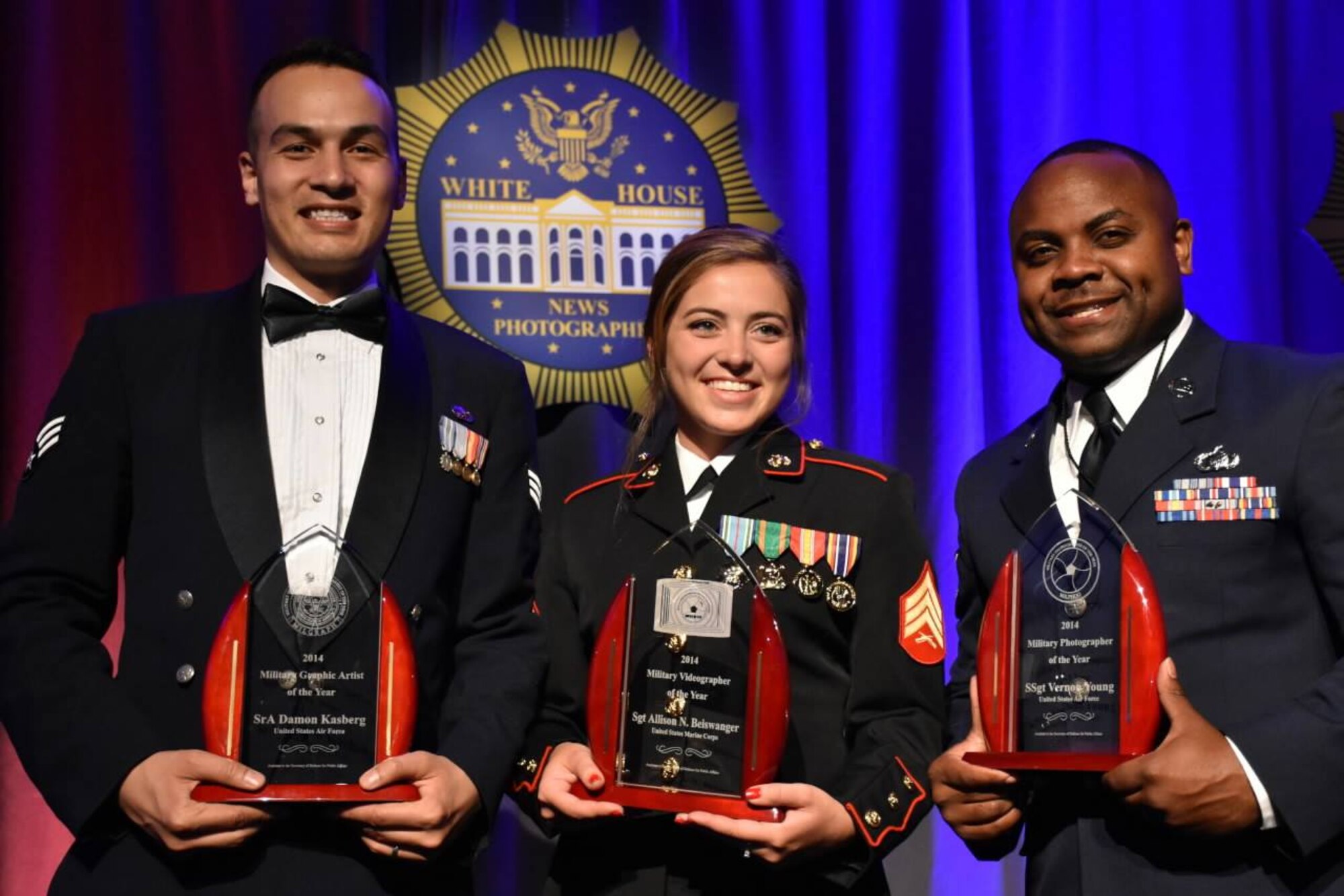 U.S. Air Force Senior Airman Damon Kasberg (left), 2014 Visual Information Award Program Military Graphic Artist of the Year from 86th Airlift Wing Public Affairs, U.S. Marine Corps Sgt. Allison N. Beiswanger, 2014 VIAP Military Videographer of the Year  from Office of USMC Communications (middle) and USAF Staff Sgt. Vernon Young (right),2014 VIAP Military Photographer of the Year from Defense Media Activity Airman Magazine, pose for a photo with their awards May 17, 2015, in the District of Columbia. Kasberg was also awarded Military Graphic Artist of the Year for 2015 and will attend a ceremony in D.C. on June 18. (Courtesy Photo)