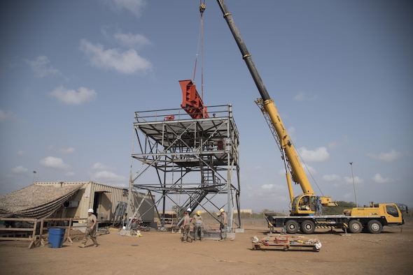 Airmen from the 205th Engineering Installation Squadron, out of Oklahoma City, install a new AN/GPN-27 Airport Surveillance Radar System tower June 4, 2016, at Camp Lemonnier, Djibouti. With coordination between the 205th EIS, U.S. Air Forces in Europe, Air Force Flight Standards Agency, U.S. Air Forces Central Command and the U.S. Navy, the new radar will increase air traffic control capabilities and safety. (U.S. Air Force photo/Staff Sgt. Tiffany DeNault)