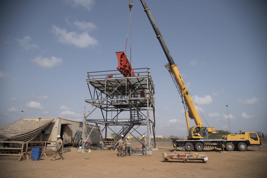 Airmen from the 205th Engineering Installation Squadron, out of Oklahoma City, install a new AN/GPN-27 Airport Surveillance Radar System tower June 4, 2016, at Camp Lemonnier, Djibouti. With coordination between the 205th EIS, U.S. Air Forces in Europe, Air Force Flight Standards Agency, U.S. Air Forces Central Command and the U.S. Navy, the new radar will increase air traffic control capabilities and safety. (U.S. Air Force photo/Staff Sgt. Tiffany DeNault)