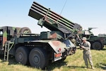Spc. Martin Fender, assigned to the 5th Battalion, 113th Field Artillery Regiment (High Mobility Artillery Rocket System), North Carolina Army National Guard, aims a 122mm WR-40 Langusta self-propelled multiple rocket launcher with the sighting mechanism at the Jaworze Training Area, Poland, during Exercise Anakonda 16 on June 5, 2016. 