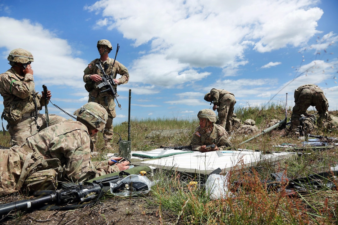 Paratroopers receive grid coordinates for a fire mission after an airborne operation during Anakonda 2016 on the Piaskowi drop zone in Drawsko Pomorskie, Poland, June 6, 2016. Army photo by Pfc. Antonio Lewis
