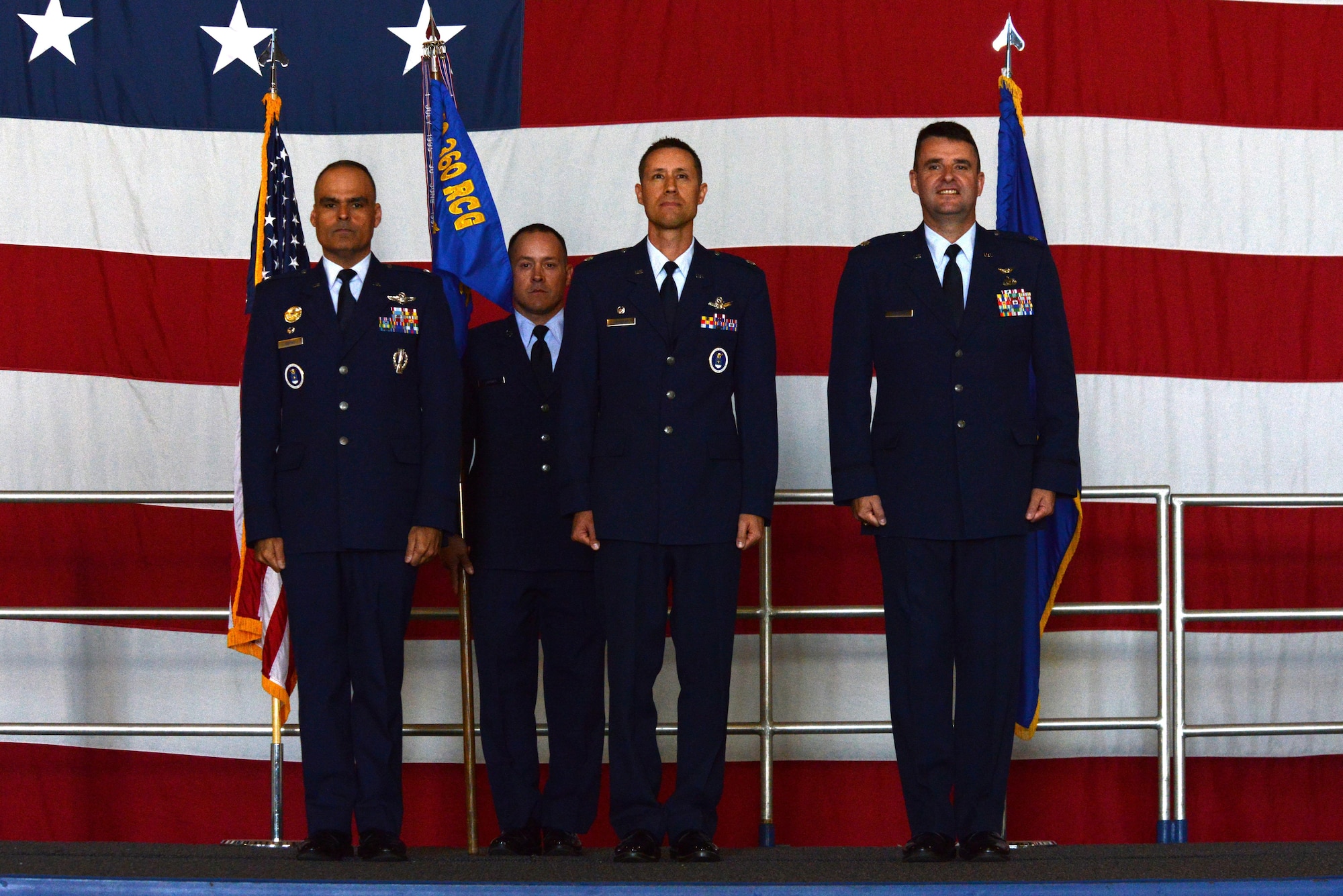 U.S. Air Force Col. Eric A Espino, 360th Recruiting Group commander, U.S. Air Force Lt. Col. Cary Belmear, 337th Recruiting Squadron commander, and U.S. Air Force Lt. Col. Layne Trosper, Air Education and Training Command executive officer to the vice commander, stand at attention before the passing of the 337th RS flag held by Master Sgt. Christopher Joyner, 337th RS first sergeant, during a change of command ceremony at Shaw Air Force Base, S.C., June 9, 2016. The change of command ceremony is the formal transfer of responsibility over a unit from one commander to another. (U.S. Air Force photo by Airman 1st Class Destinee Dougherty)