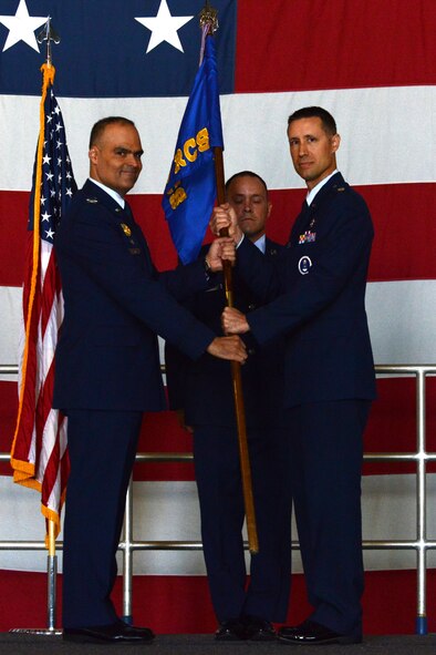 U.S. Air Force Lt. Col. Cary Belmear, 337th Recruiting Squadron commander, hands the 337th RS guidon to Col. Eric A. Espino, 360th Recruiting Group commander, during a change of command ceremony at Shaw Air Force Base, S.C., June 9, 2016. During the change of command ceremony, Belmear relinquished command to Lt. Col. Layne Trosper, Air Education and Training Command executive officer to the vice commander. Change of command ceremonies can be traced back centuries to the Roman Empire. (U.S. Air Force photo by Airman 1st Class Destinee Dougherty)