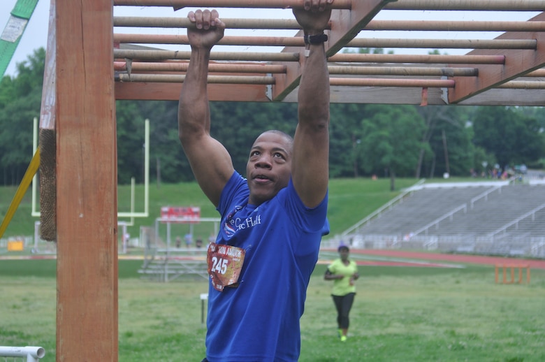 Chester McMillon of Woodbridge, Virginia, concentrates on navigating the monkey bars.