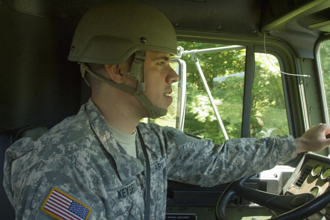 JOINT BASE MCGUIRE-DIX-LAKEHURST, N.J. - Spc. Scott Keyser, a heavy equipment operator for the Reading, Pa.-based 333rd Engineer Company, practices his driving skills in a light equipment transport truck during training exercise Castle Installation Related Construction 2016. (U.S. Army photo by Sgt. Anshu Pandeya, 372nd Mobile Public Affairs Detachment)