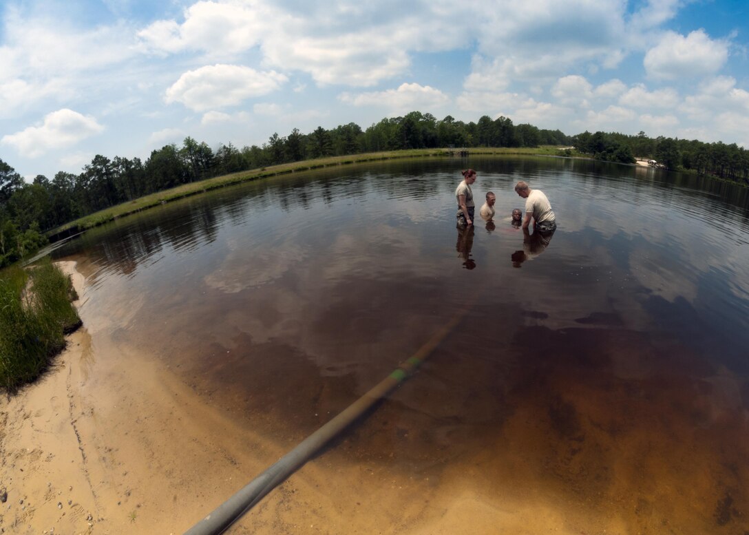 U.S. Army Reserve water treatment specialists, with the 810th Quartermaster Company, an Army Reserve unit from Maineville, Ohio, secure a water pump in Mott Lake during the annual Quartermaster Liquid Logistics Exercise (QLLEX), at Fort Bragg, N.C., June 14, 2016. QLLEX is an annual logistical movement event that will transport necessary petroleum and purified water throughout the U.S. (Sgt. Christopher Bigelow / Released)