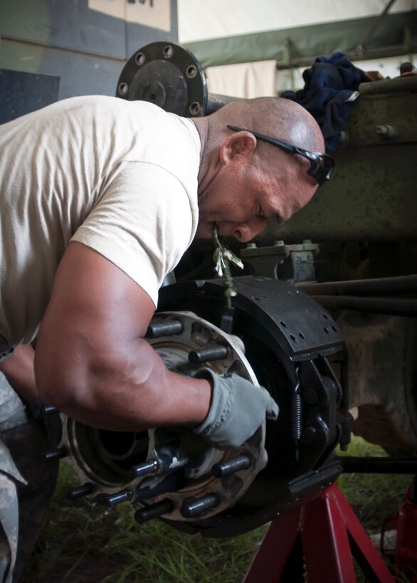 Spc. Anthony Carter, a light wheel vehicle mechanic with the 655th Transportation Company, provides maintenance to a M916 Light Equipment Transporter, during the annual Quartermaster Liquid Logistics Exercise (QLLEX), at Fort Bragg, N.C., June 14, 2016. QLLEX is an annual logistical movement event that will transport necessary petroleum and purified water throughout the U.S. (Sgt. Christopher Bigelow / Released)