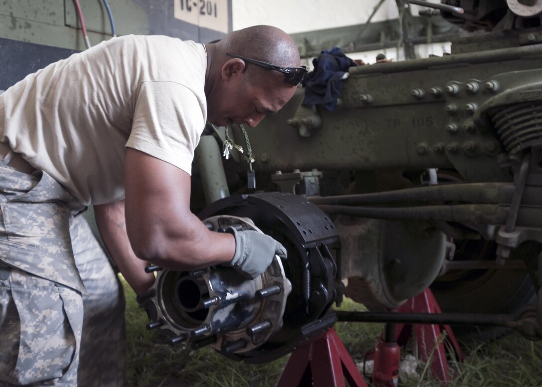 Spc. Anthony Carter, a light wheel vehicle mechanic with the 655th Transportation Company, provides maintenance to a M916 Light Equipment Transporter, during the annual Quartermaster Liquid Logistics Exercise (QLLEX), at Fort Bragg, N.C., June 14, 2016. QLLEX is an annual logistical movement event that will transport necessary petroleum and purified water throughout the U.S. (Sgt. Christopher Bigelow / Released)