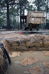 Murky water waits to be used by a Laundry and Bath System operated by Army Reserve Soldiers from the 597th Quartermaster Company (Laundry and Bath), during the annual Quartermaster Liquid Logistics Exercise (QLLEX), at Fort Bragg, N.C., June 14, 2016. QLLEX is an annual logistical movement event that will transport necessary petroleum and purified water throughout the U.S. (Sgt. Christopher Bigelow / Released)