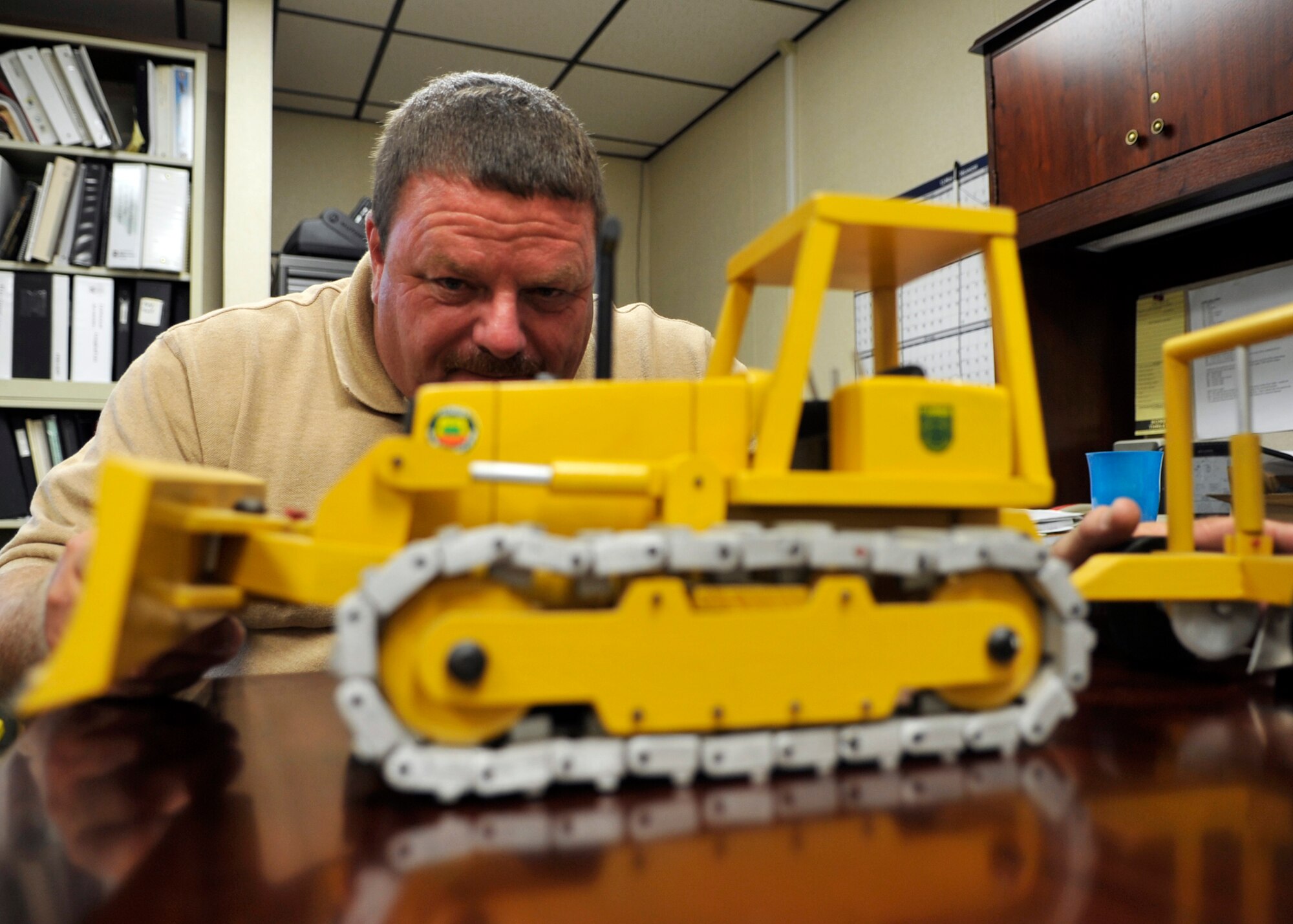Richard Turner, a forest technician assigned to the 325th Civil Engineer Squadron Natural Resources, inspects a home-made wooden toy at the Natural Resources building June 14, 2016. Turner was chosen as the ‘Unsung Hero’ as part of Tyndall Air Force Base’s squadron of the week program, and one of his hobbies includes woodworking. (U.S. Air Force photo by Senior Airman Sergio A. Gamboa/Released)