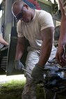 Spc. Anthony Carter, with the 655th Transportation Company, an Army Reserve unit based out of Millington, Tenn., replaces a wheel hub on a M916 Light Equipment Transport truck during the annual Quartermaster Liquid Logistics Exercise (QLLEX) at Fort Bragg, N.C., June 15, 2016. (U.S. Army photo by Staff Sgt. Dalton Smith/Released)