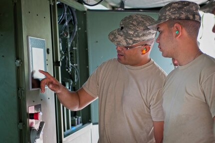 Spc. Joel Cruz, with the 597th Quartermaster Company, an Army Reserve unit based out of Puerto Nuevo, Puerto Rico, instructs fellow Soldiers how to operate the Laundry Advanced System (LADS) during the annual Quartermaster Liquid Logistics Exercise (QLLEX) at Fort Bragg, N.C., June 15, 2016. (U.S. Army photo by Staff Sgt. Dalton Smith/Released)