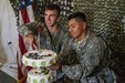 Pfc. Jose Rincon and Spc. Thomas Branson, 311th Sustainment Command (Expeditionary), have the honor of cutting the Army birthday cake they baked and decorated earlier that day, Camp Roberts, Calif., June 14, 2016.