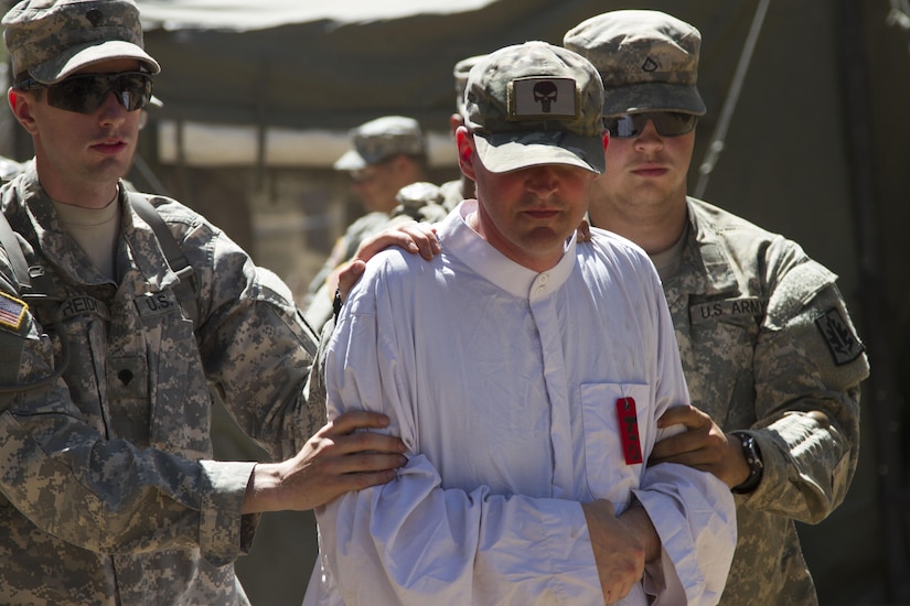 U.S. Army Reserve Soldiers, 812th Military Police Company, Orangeburg, N.Y., transport a costumed role player during an exercise in detainee transfer operations as part of Combat Support Training Exercise 91-16-02, Fort Hunter Liggett, Calif., on June 13, 2016. As the largest U.S. Army Reserve training exercise, CSTX 91-16-02 provides Soldiers with unique opportunities to sharpen their technical and tactical skills in combat-like conditions. (U.S. Army photo by Sgt. Krista L. Rayford, 367th Mobile Public Affairs Detachment)