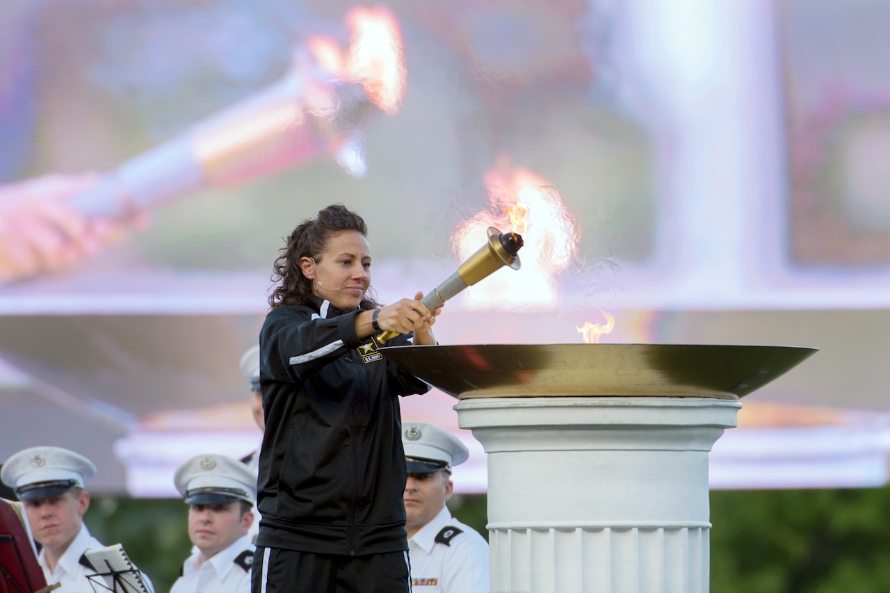 Army Capt. Kelly Elmlinger lights the 2016 Department of Defense Warrior Games torch during opening ceremonies for the games at the U.S. Military Academy in West Point, N.Y., June 15, 2016. DoD photo by EJ Hersom