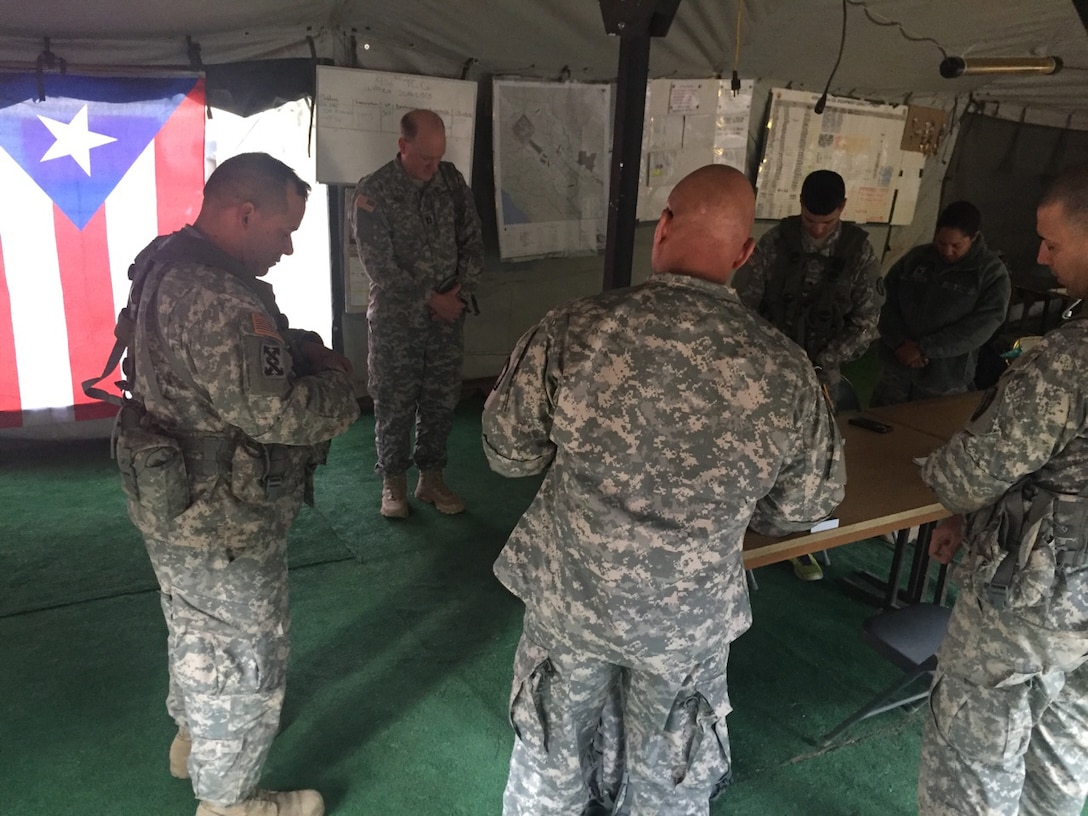 Soldiers of the 398th Combat Sustainment Support Battalion bow their heads in prayer during WAREX 91-16-02 at Fort Hunter Liggett, Cali.  Chaplains provided emotional and spiritual support during the exercise.