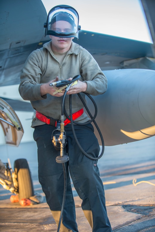 Airman 1st Class Ryan Bateman, a 354th Aircraft Maintenance Squadron assistant dedicated crew chief, tops off the air in the tire of an F-16 Fighting Falcon fighter aircraft flown by the 18th Aggressor Squadron (18th AGRS) while working swing shift June 14, 2016, during RED FLAG-Alaska (RF-A) 16-2 at Eielson Air Force Base, Alaska. The 18th AGRS supports RF-A by sharing its knowledge of flying to participating units and ensuring the U.S. and its allies receive the best air combat training possible. (U.S. Air Force photo by Staff Sgt. Shawn Nickel/Released)