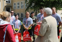 Retired Polish Army Colonel Krzysztof Zielinska thanks U.S. Army Reserve Soldiers from the 364th Expeditionary Sustainment Command Marysville, Washington, for their participation in a 10-kilometer race commemorating a local town hero and his late wife, Halina, in Sulejowek June 11. The 364th ESC is currently serving in Poland in support of Anakonda 16, a Polish-led national event that seeks to train, exercise and integrate Polish national command and force structures into an Allied, joint, multinational environment. (Photo by Capt. A. Sean Taylor, 649th RSG)