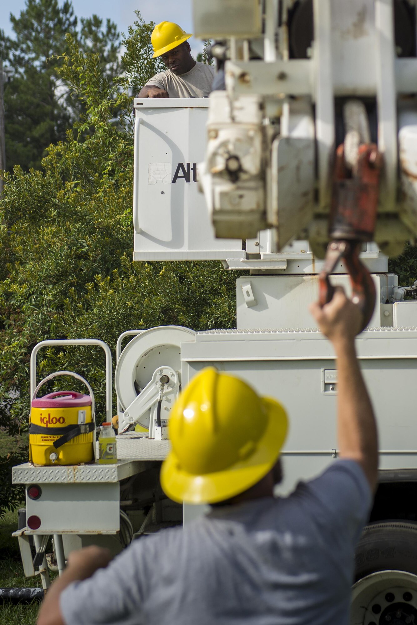 U.S. Air Force Staff Sgt. Devere Donnell, 202nd Red Horse Squadron electrical systems apprentice, and Cade Siebenaler, 23d Civil Engineer Squadron electrical systems technician, ensure the boom attached to a linemen’s truck is working correctly, June 15, 2016, at Moody Air Force Base, Ga. Airmen first lift and remove the older light pole from the ground before lodging the new pole into the ground. (U.S. Air Force photo by Airman Daniel Snider/Released)

