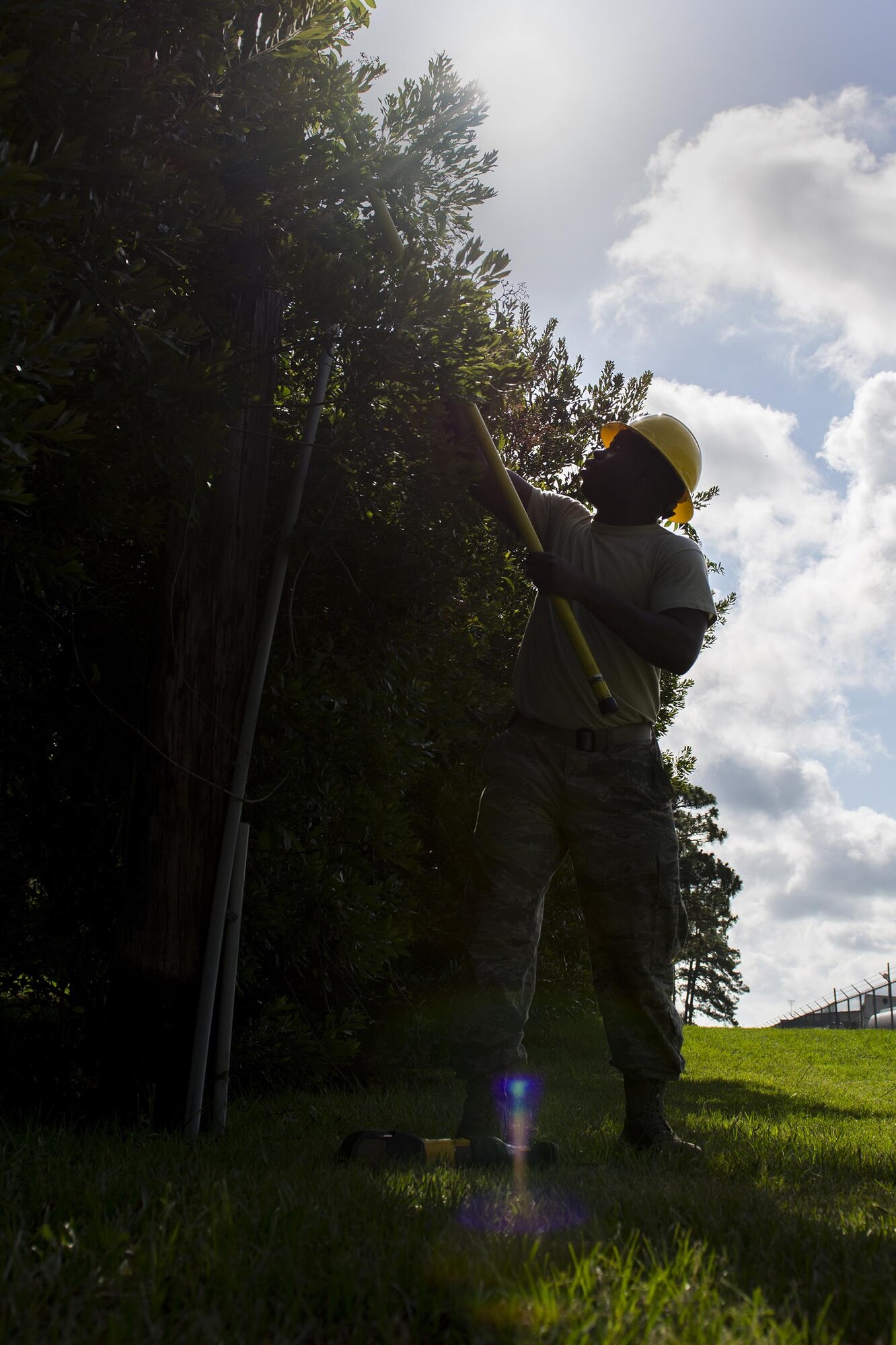 U.S. Air Force Staff Sgt. Justin Tucker, 23d Civil Engineer Squadron electrical systems craftsman, guides a rope, June 15, 2016, at Moody Air Force Base, Ga. The 23d CES designs, constructs and maintains base infrastructure and facilities. (U.S. Air Force photo by Airman Daniel Snider/Released)