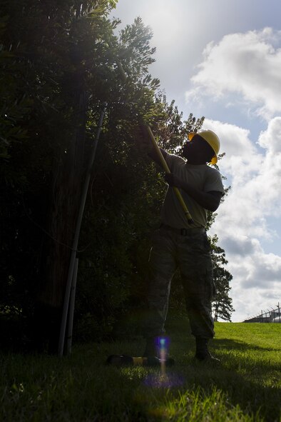 U.S. Air Force Staff Sgt. Justin Tucker, 23d Civil Engineer Squadron electrical systems craftsman, guides a rope, June 15, 2016, at Moody Air Force Base, Ga. The 23d CES designs, constructs and maintains base infrastructure and facilities. (U.S. Air Force photo by Airman Daniel Snider/Released)