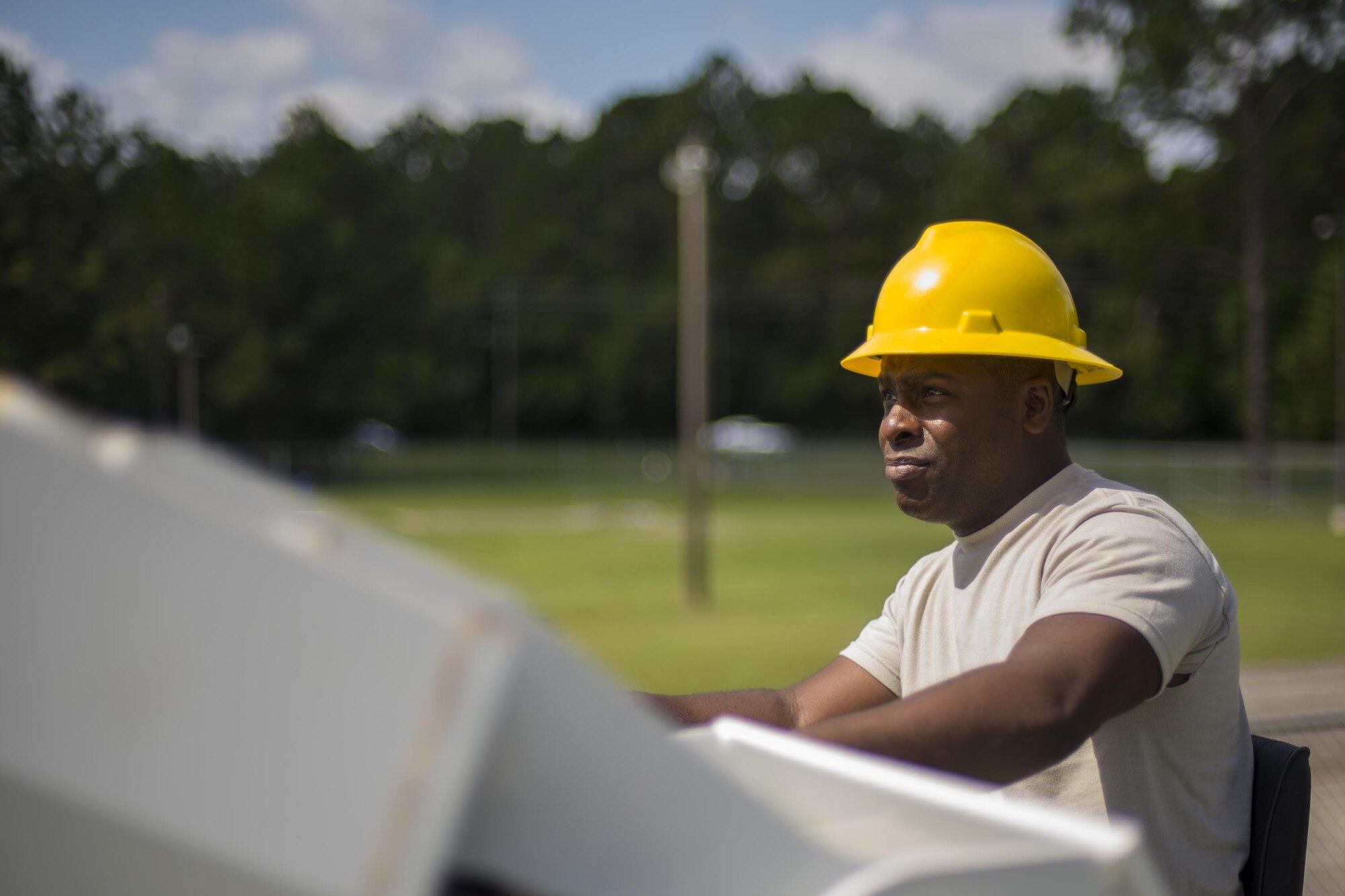 U.S. Air Force Staff Sgt. Devere Donnell, 202nd Red Horse Squadron electrical systems apprentice, operates machinery during the removal and replacement of light fixtures, June 15, 2016, at Moody Air Force Base, Ga. National guardsmen from the 202nd RHS often come from Camp Blinding, Fl. to train and work alongside the 23d Civil Engineer Squadron. (U.S. Air Force photo by Airman Daniel Snider/Released)
