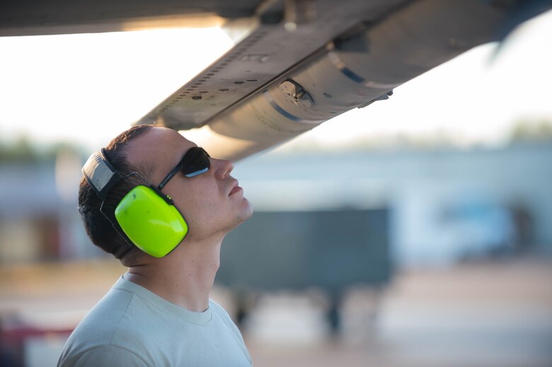 U.S. Air Force Staff Sgt. Nathan Mendoza, a 354th Maintenance Squadron aircraft armament systems craftsman, inspects a Captive AIM-9 missile after loading it onto an  F-16 Fighting Falcon fighter aircraft while working swing shift June 14, 2016, during RED FLAG-Alaska (RF-A) 16-2 at Eielson Air Force Base, Alaska. Jets are flown almost double the normal hours during RF-A, increasing the need for maintenance, which provides training for support personnel in sustainment of large-force deployed air operations. (U.S. Air Force photo by Staff Sgt. Shawn Nickel/Released)