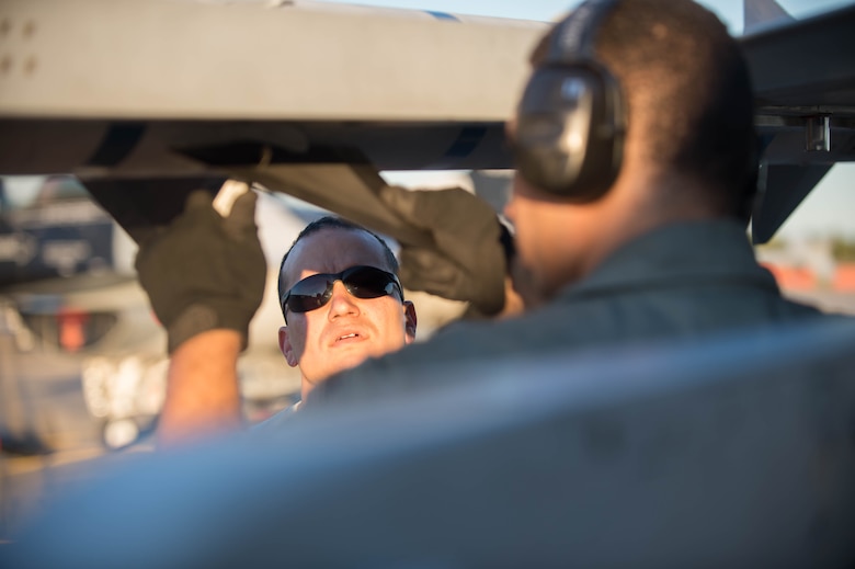 U.S. Air Force Staff Sgt. Nathan Mendoza, a 354th Maintenance Squadron aircraft armament systems craftsman, inspects a Captive AIM-9 missile after loading it onto an  F-16 Fighting Falcon fighter aircraft while working swing shift June 14, 2016, during RED FLAG-Alaska (RF-A) 16-2 at Eielson Air Force Base, Alaska. Jets are flown almost double the normal hours during RF-A, increasing the need for maintenance, which provides training for support personnel in sustainment of large-force deployed air operations. (U.S. Air Force photo by Staff Sgt. Shawn Nickel/Released)