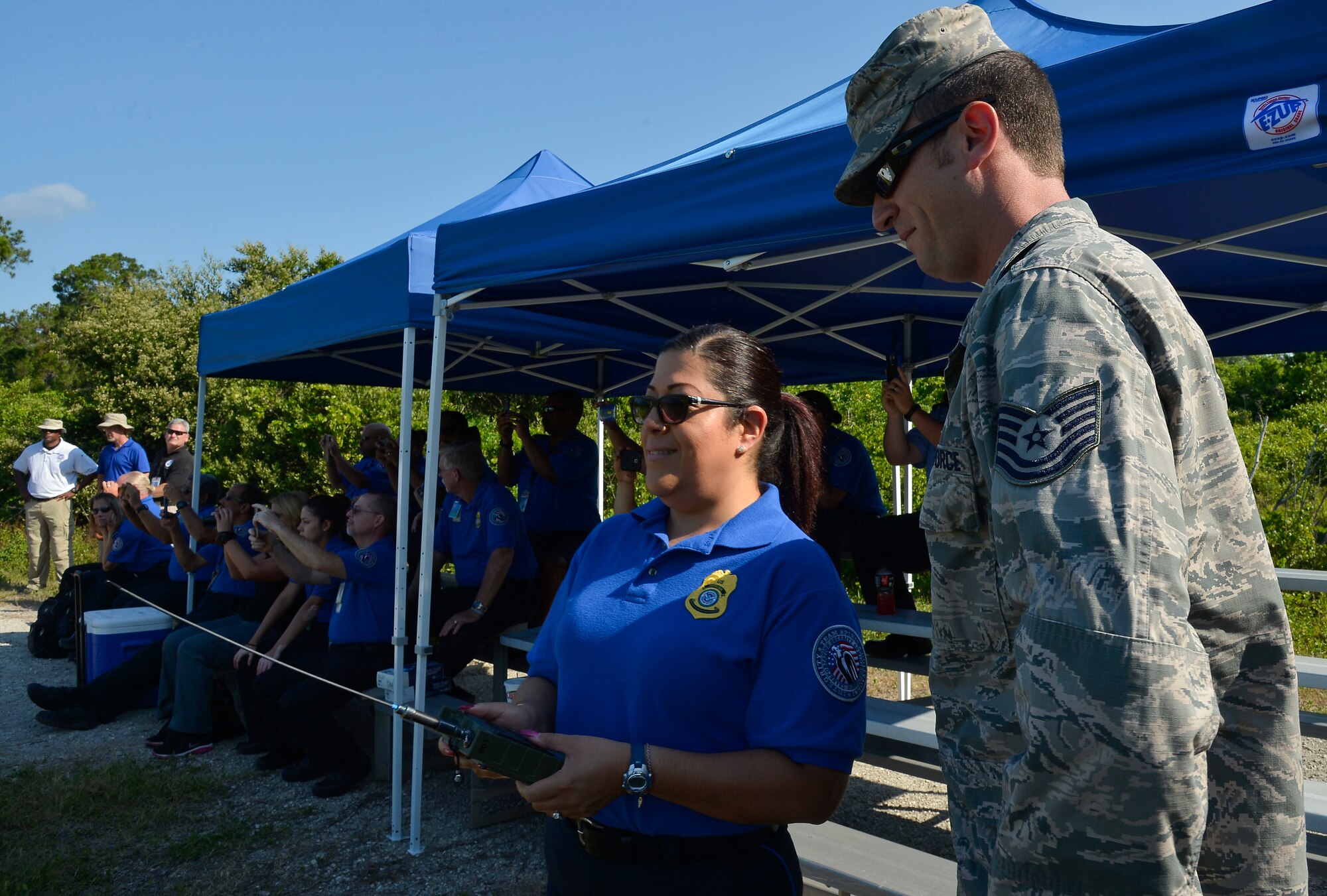Tech. Sgt. Clay Gorham, explosive ordnance team leader assigned to the 6th Civil Engineer Squadron (CES), instructs a Transportation Security Administration (TSA) employee on how to detonate an improvised explosive device (IED) at MacDill Air Force Base, Fla., June 1, 2016. The 6th CES partnered with TSA to demonstrate the various explosive capabilities and impacts of IEDs. (U.S. Air Force photo by Staff Sgt. Shandresha Mitchell)
